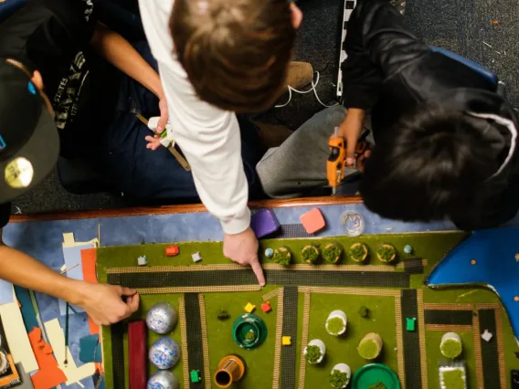 Students pointing at a 3D map