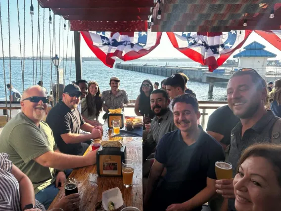 Group at a table of a restaurant smiling for camera