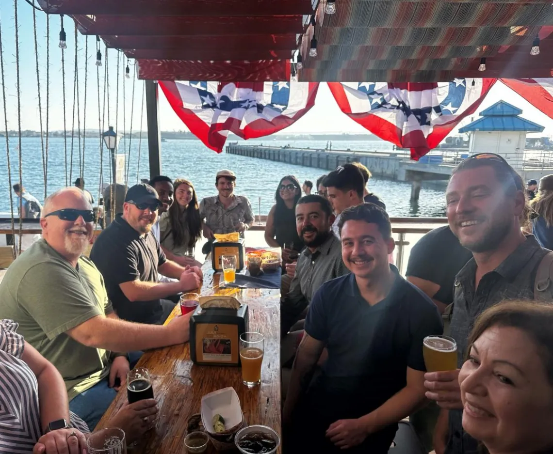 Group at a table of a restaurant smiling for camera