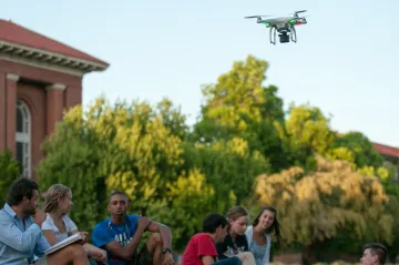 students flying drone